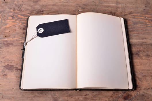 an old empty book on a wooden board background