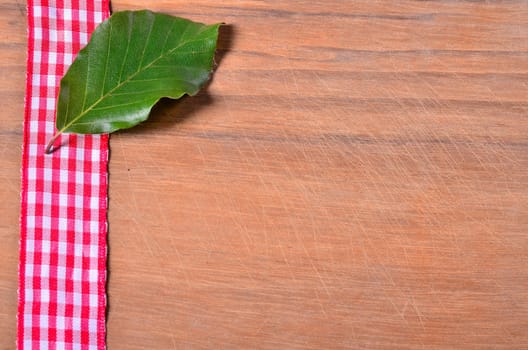 old wood background with red ribbon