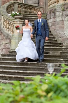 Bridal couple on castle stairs
