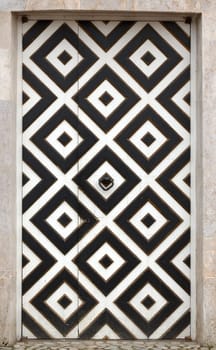 old doors of the fortress with a geometric pattern
