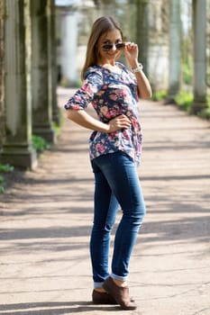 beautiful young woman in full length in sunglasses.