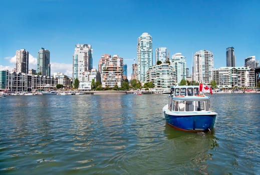 A passenger ferry is commuting between Granville Island and Vancouver downtown.