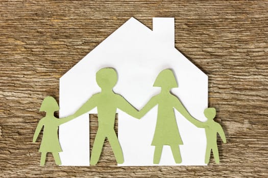 Paper cut of a house with family