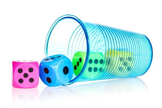Plastic cup with colorful dice over a white background