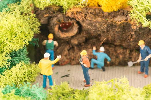 Miniature workers clearing a pathway after storm close up