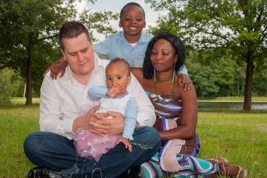 Happy mixed family is having a nice day in the park