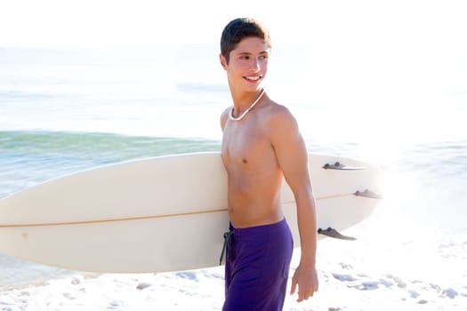 Surfer handsome boy teenager with surfboard in beach shore