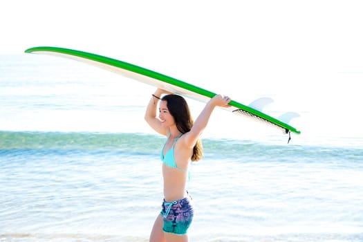 Surf beautiful girl with green surfboard in beach shore