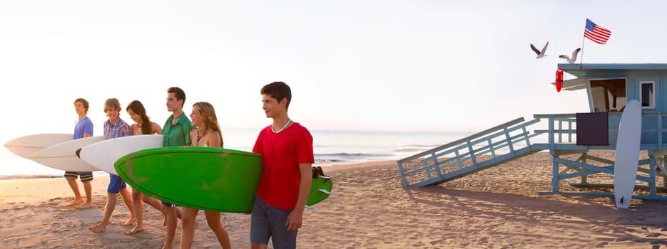 Surfer teenagers boys and girls walking on California beach at Santa Monica