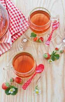 Breakfast tea with fresh strawberries in glass cups