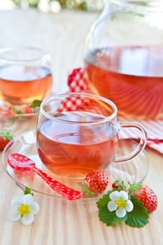 Breakfast tea with fresh strawberries in glass cups