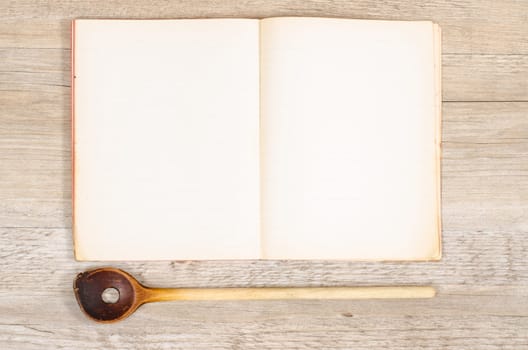 Old paper from a book with wooden spoon and text space for advertising space