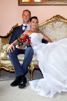 Bridal couple on old sofa