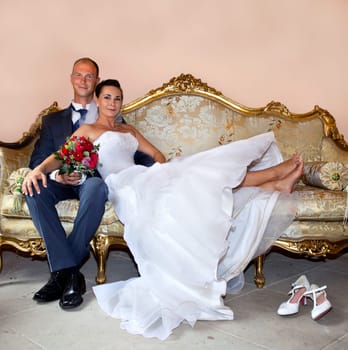 Bridal couple on old sofa