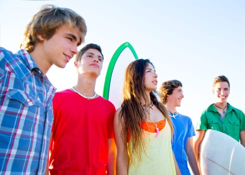 Teenager surfers boys and girls group happy in beach shore high key