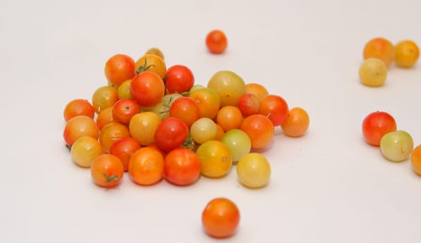 Multicolored cherry tomatoes on a white background