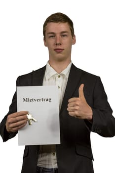 Young man holds a lease in his hands and is happy