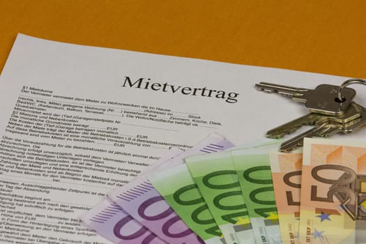 Rental agreement with house keys and banknotes