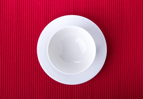 Empty bowl isolated on red background