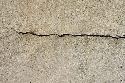 The close-up of a façade with a crack,usable as a background.