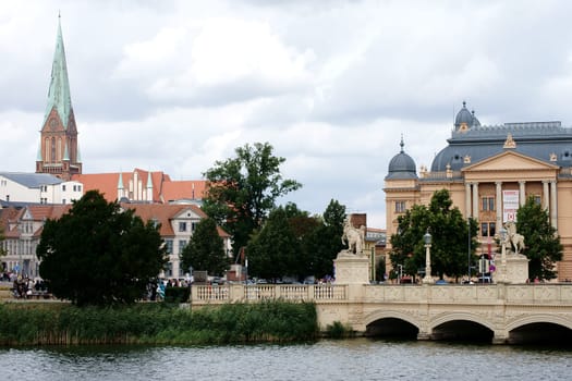 Schwerin,Germany – August 11,2013: The Schwerin Castle Bridge with a view of Schwerin Cathedral and the State Theatre on August 11,2013 in Schwerin.