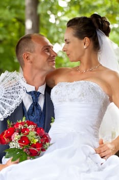 Wedding couple sitting in the castle park