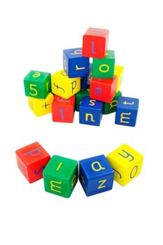 child's building blocks in primary colours on a white background. The word at the front spells 'play'
