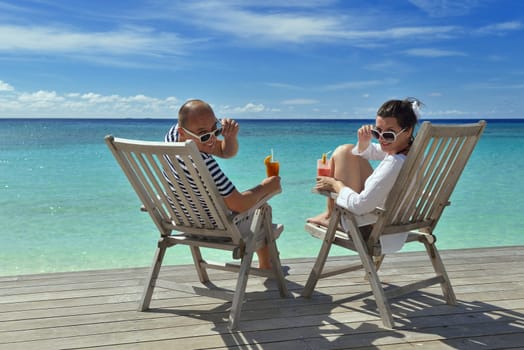 happy young couple relax and take fresh drink at summer vacation