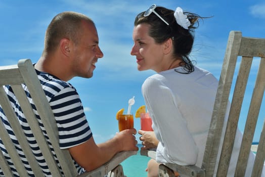happy young couple relax and take fresh drink at summer vacation