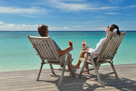 happy young couple relax and take fresh drink at summer vacation