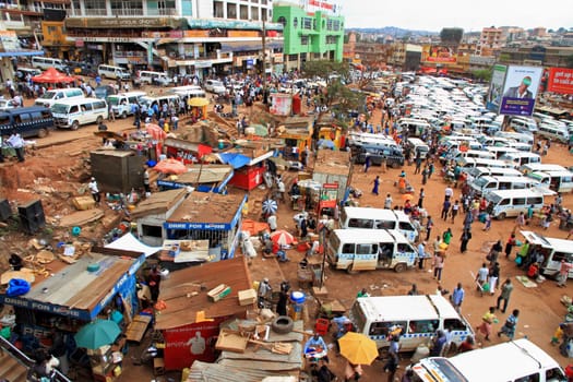 KAMPALA, UGANDA - SEPTEMBER 28, 2012. People and taxis move about their busy day in the downtown taxi park in Kampala, Uganda on September 28,2012.
