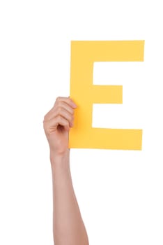 A Hand Holds a Yellow E, Isolated