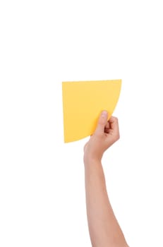 A Hand Holds a Yellow Piece of Paper With Copyspace, Isolated