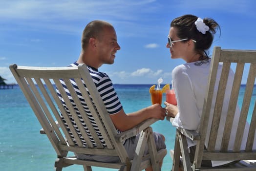 happy young couple relax and take fresh drink at summer vacation