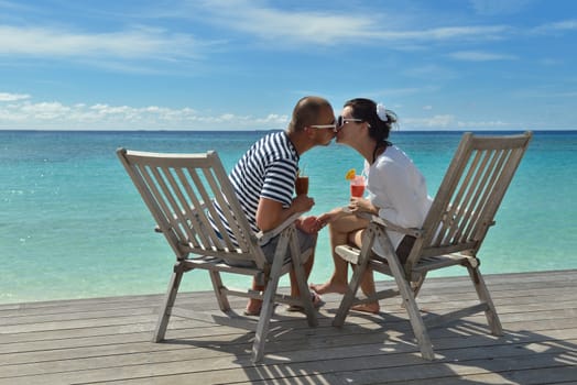 happy young couple relax and take fresh drink at summer vacation