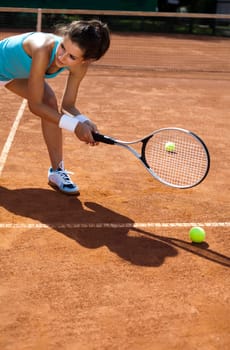 Young woman tennis player on the court