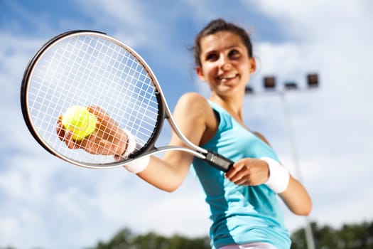Young woman tennis player on the court