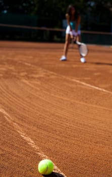 Young woman tennis player on the court
