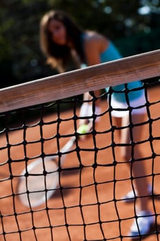 Young woman tennis player on the court