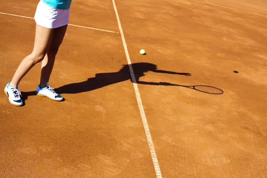 Young woman tennis player on the court