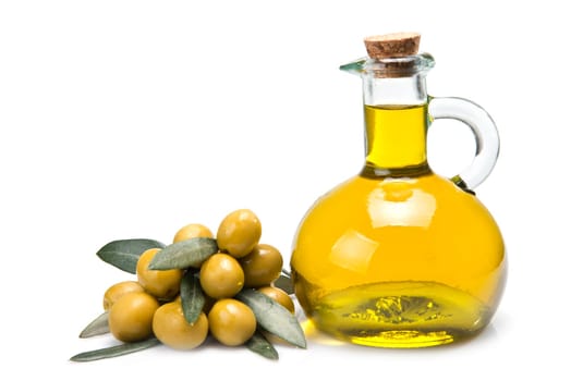 A jar with olive oil and some green olives isolated over a white background.