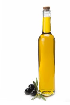 A classical glass bottle of olive oil and some black olives isolated over a white background
