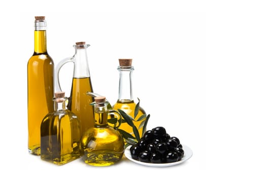 Jars with olive oil and some olives isolated over a white background.