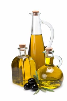 Jars with olive oil and some olives isolated over a white background.