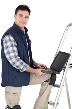 Tiler stood with ladder and laptop