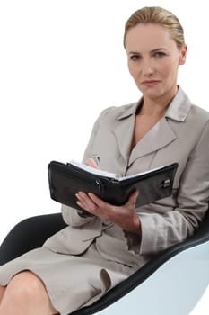Woman sat taking notes