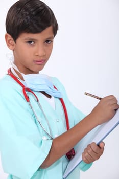 Little boy with chart dressed-up as doctor