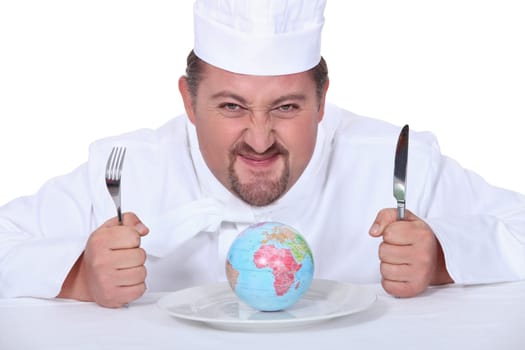 Chef sat with miniature globe on plate