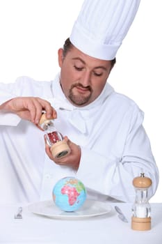 a cook seasoning a globe