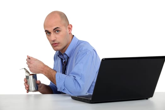 executive eating out of tin can